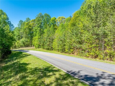 View of road featuring a wooded view