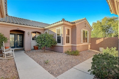 View of property exterior with a tile roof and stu