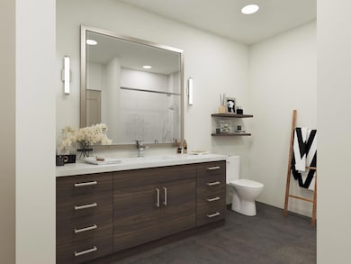 Full bath featuring a shower stall, toilet, vanit