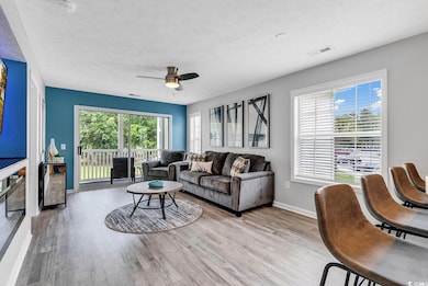 Living room featuring light wood-style flooring, b