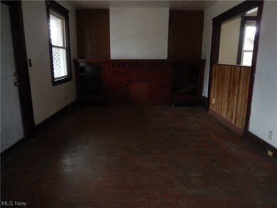Unfurnished living room with a fireplace and dark hardwood / wood-style flooring