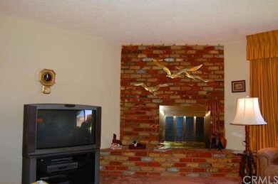 Living room with cozy used brick fireplace and hea