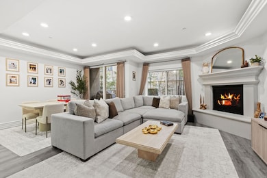 Cozy fireplace, custom crown molding + voice command recessed lighting.
