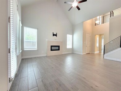 Unfurnished living room with high vaulted ceiling
