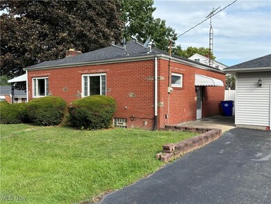 View of side of property with a lawn