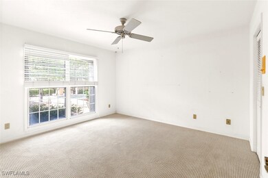 Unfurnished room featuring carpet and ceiling fan