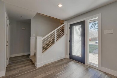 The front door entry leads to new hardwood floors 