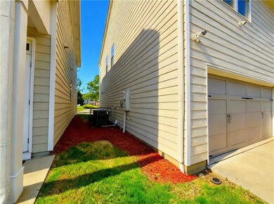 View of side of home with a garage and a central air condition unit