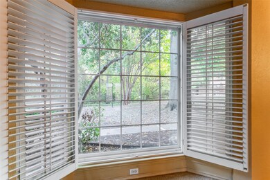 View from living room to park-like area and creek. Lots of windows