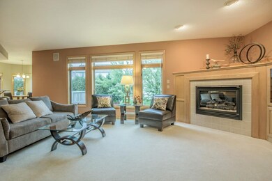 Living room with grand wall-of-windows to bring th