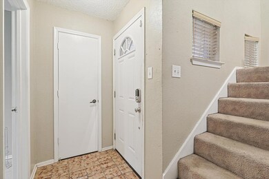 Inside entry. Front door, coat closet, and half ba