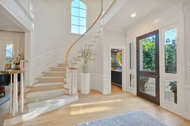 Spacious entry featuring a grand staircase with ab