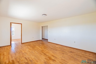 Unfurnished room featuring light wood-type flooring and baseboards