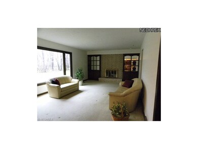 Family room with picture window of back yard.