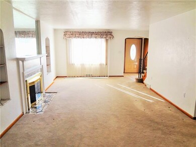 The spacious Living room with gas fireplace and ba