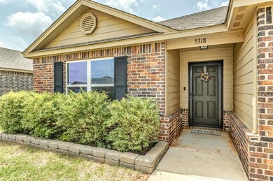Doorway to property with brick siding and roof with shingles