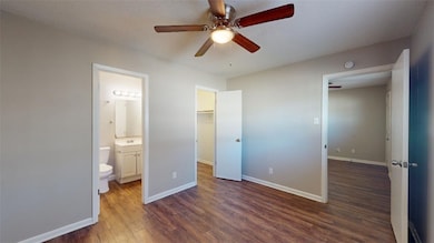 Unfurnished bedroom with baseboards, a walk in clo