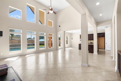 The living room is enormous. Tall ceilings, big wi