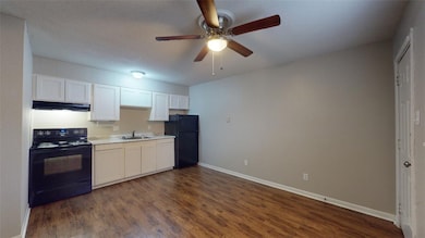 Kitchen featuring black appliances, under cabinet
