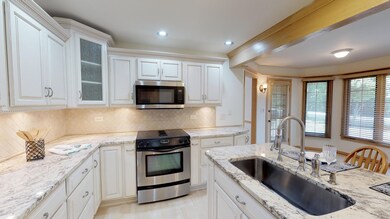 Granite counters, white antiqued cabinetry with so