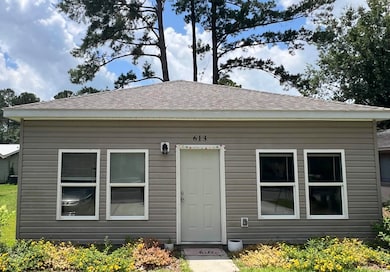 Rear view of property featuring a shingled roof