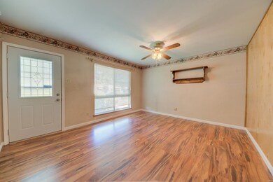 Laminate flooring in living room with ceiling fan 
