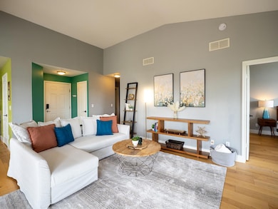 Living room with high vaulted ceiling and light w