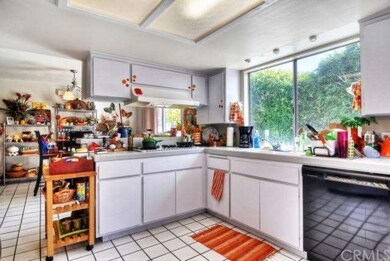 Large kitchen area looks out onto back patio and p