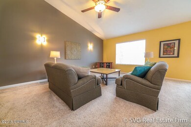 Cozy living room is fully carpeted