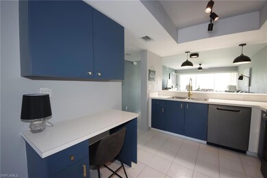 Kitchen featuring sink, blue cabinetry, dishwasher