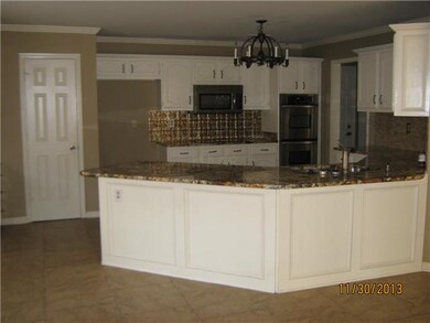 Kitchen has granite counter tops, breakfast bar an