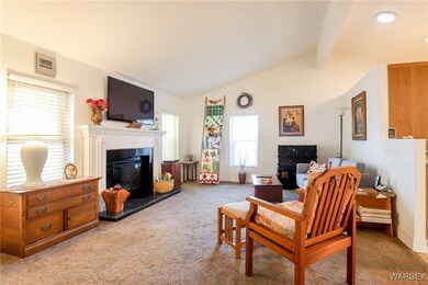Living room with light colored carpet, plenty of n