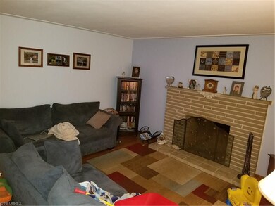 Spacious living room with brick fireplace and hard