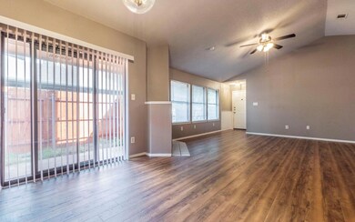 Spare room featuring ceiling fan, dark wood finis