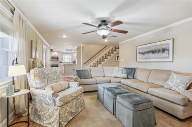 Den with tile floor and crown molding.