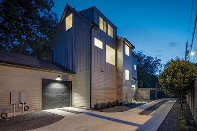 View of side of property featuring concrete drive