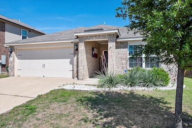 View of front of house featuring a garage and a front lawn