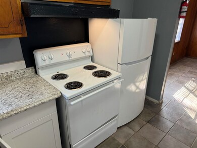 Kitchen with white appliances, ventilation hood, l