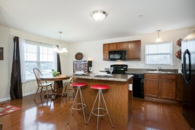 The kitchen features hardwood floors, a breakfast 