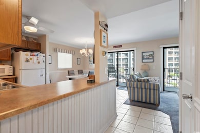 Kitchen with ceiling fan with notable chandelier, 