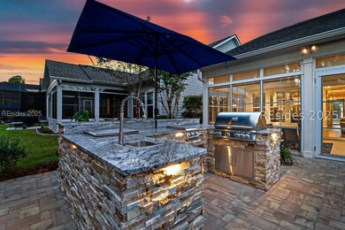 Outdoor kitchen with grill, side burner, and sink