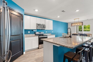 Kitchen with light wood-style flooring, a sink, li