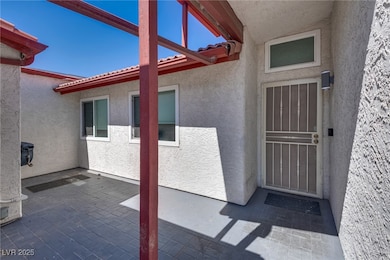 View of exterior entry featuring a patio and stucc