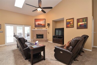 Family room with vaulted ceiling, skylights, wood 