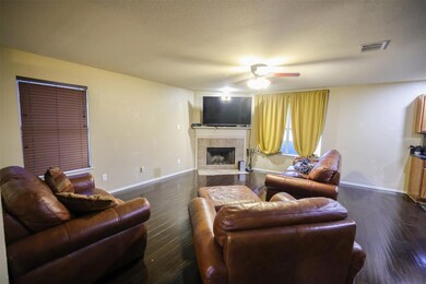 Living room featuring ceiling fan, dark wood-type 