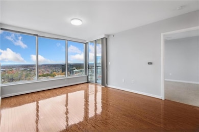 Unfurnished room featuring wood finished floors and baseboards