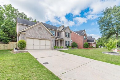 Traditional-style house with brick siding, concrete driveway, and a garage