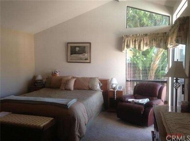 Master bedroom with vaulted ceilings and a sliding