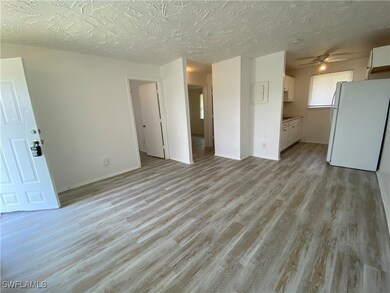 Unfurnished living room with light wood-style floo