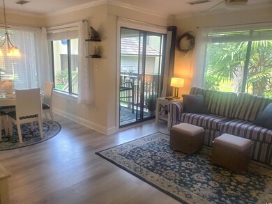 Living room featuring crown molding, healthy amount of natural light, and wood finished floors
